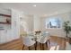 Bright dining room features hardwood floors and a modern glass table set at 525 W Midway Blvd, Broomfield, CO 80020