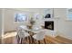 Bright dining room with modern table, fireplace, and large windows offering natural light at 525 W Midway Blvd, Broomfield, CO 80020