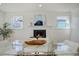 Dining room with a fireplace, wood floors, and large windows at 525 W Midway Blvd, Broomfield, CO 80020