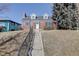 Charming brick home featuring black shutters and a long staircase leading to the entrance at 525 W Midway Blvd, Broomfield, CO 80020