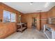 Spacious garage with wood paneled walls, a workbench and storage shelves at 525 W Midway Blvd, Broomfield, CO 80020