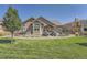 Landscaped backyard with patio, pergola, and lawn at 4993 Sedona Cir, Parker, CO 80134