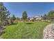 Large backyard with manicured lawn and rock landscaping at 4993 Sedona Cir, Parker, CO 80134