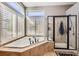 Relaxing bathroom featuring a corner tub and separate shower at 4993 Sedona Cir, Parker, CO 80134