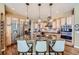 Modern kitchen with granite island, stainless steel appliances, and hardwood floors at 4993 Sedona Cir, Parker, CO 80134