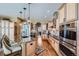 Gourmet kitchen featuring granite island, stainless steel appliances, and hardwood floors at 4993 Sedona Cir, Parker, CO 80134