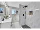Modern bathroom featuring white marble tile and matte black fixtures at 3272 W Stanford W Ave, Englewood, CO 80110