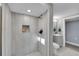 Updated bathroom featuring modern tile, a walk-in shower, and updated fixtures at 3272 W Stanford W Ave, Englewood, CO 80110