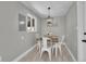 Small dining room with white table, decor and a modern light fixture at 3272 W Stanford W Ave, Englewood, CO 80110