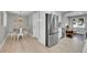 View of the dining room with dining table and stainless steel refrigerator at 3272 W Stanford W Ave, Englewood, CO 80110