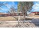 Charming single-story brick home with mature trees and a well-kept lawn on a sunny day at 3272 W Stanford W Ave, Englewood, CO 80110