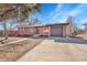 Charming brick home featuring a convenient attached garage and a well-manicured front yard at 3272 W Stanford W Ave, Englewood, CO 80110