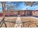 Charming brick home with a well-maintained front yard and attached garage at 3272 W Stanford W Ave, Englewood, CO 80110