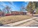 Charming brick home with a well-maintained front yard on a sunny day at 3272 W Stanford W Ave, Englewood, CO 80110