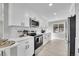 Bright kitchen with white cabinets, stainless steel appliances, and modern countertops at 3272 W Stanford W Ave, Englewood, CO 80110
