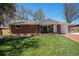 Inviting single-story red brick home with lush green lawn and charming front porch at 7071 Beach St, Westminster, CO 80030