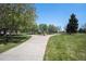 Well-maintained park with walking paths, lush green grass, and a variety of mature trees at 7071 Beach St, Westminster, CO 80030