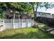 Backyard featuring a well-maintained lawn, wooden fencing, and mature trees providing shade and privacy at 17657 E Prentice Cir, Aurora, CO 80015