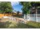 Backyard featuring a multilevel yard with wooden fencing, mature trees, and a lush green lawn at 17657 E Prentice Cir, Aurora, CO 80015