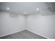 Unfinished basement space with gray carpeting and modern recessed lighting at 17657 E Prentice Cir, Aurora, CO 80015