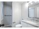 Bright bathroom features a walk-in shower, vanity with granite countertop, and contemporary lighting at 17657 E Prentice Cir, Aurora, CO 80015