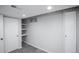 View of finished bedroom with gray walls and carpet, bright lighting, closet and storage shelves at 17657 E Prentice Cir, Aurora, CO 80015