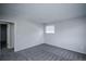 Simple bedroom features plush carpeting, a window, and access to an adjacent room at 17657 E Prentice Cir, Aurora, CO 80015