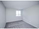 Minimalist bedroom features plush carpeting, a window, and neutral walls at 17657 E Prentice Cir, Aurora, CO 80015