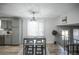 Stylish dining area featuring neutral paint, bar stool seating, and ample natural light at 17657 E Prentice Cir, Aurora, CO 80015