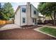 Exterior shot of a home with a brick chimney, nice landscaping, and a wooden deck at 17657 E Prentice Cir, Aurora, CO 80015