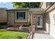 Inviting front entrance featuring a brick facade, covered porch, and well-maintained landscaping at 17657 E Prentice Cir, Aurora, CO 80015