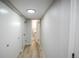 Hallway featuring wood-look flooring, closet space, and an open door to bathroom at 17657 E Prentice Cir, Aurora, CO 80015