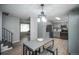 Open concept kitchen with eat-in dining area with stainless steel appliances and bar stool seating at 17657 E Prentice Cir, Aurora, CO 80015