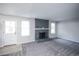 Bright living room with a brick fireplace and plush gray carpeting throughout at 17657 E Prentice Cir, Aurora, CO 80015