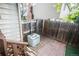 A fenced patio area with brick pavers, housing an AC unit, creating a functional outdoor space at 17657 E Prentice Cir, Aurora, CO 80015