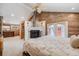 Open concept bedroom with fireplace, closet with barn door and vaulted ceilings with wood planking at 935 Newark St, Aurora, CO 80010