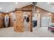 Spacious bedroom with fireplace, French doors, wood walls and closet with barn door at 935 Newark St, Aurora, CO 80010