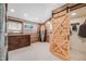 Bedroom with wood plank accent wall, large closet with sliding barn door, and wooden dresser at 935 Newark St, Aurora, CO 80010
