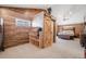 Bedroom with wood plank accent wall, large closet with sliding barn door, and carpeted floors at 935 Newark St, Aurora, CO 80010