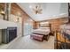 Bedroom with wood plank accent walls, fireplace, ceiling fan, and French doors at 935 Newark St, Aurora, CO 80010
