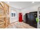 Bonus room with wood-look floors, a red refrigerator, and safe storage at 935 Newark St, Aurora, CO 80010