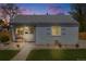 Charming single-story home featuring a well-maintained lawn and inviting front porch at 935 Newark St, Aurora, CO 80010