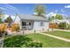 Charming home with a green lawn, walkway, and fenced yard for outdoor enjoyment at 935 Newark St, Aurora, CO 80010