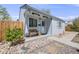 Charming home featuring a cozy front porch, decorative bench, and well-maintained landscaping at 935 Newark St, Aurora, CO 80010