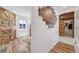 Hallway featuring wood-look floors, decorative wood accent wall, and sliding barn doors at 935 Newark St, Aurora, CO 80010