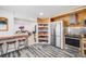 Kitchen with stainless steel appliances, wood countertops, open pantry, and counter seating at 935 Newark St, Aurora, CO 80010