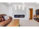 Cozy living room featuring a modern electric fireplace and comfortable seating at 935 Newark St, Aurora, CO 80010