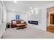 Bright living room with an electric fireplace, leather sofa, and stylish accents at 935 Newark St, Aurora, CO 80010