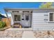 Inviting front porch featuring a bench, heaters, and stylish number display at 935 Newark St, Aurora, CO 80010