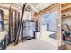 Open shed with tool chest, workbench, and access to the backyard and exterior door at 935 Newark St, Aurora, CO 80010